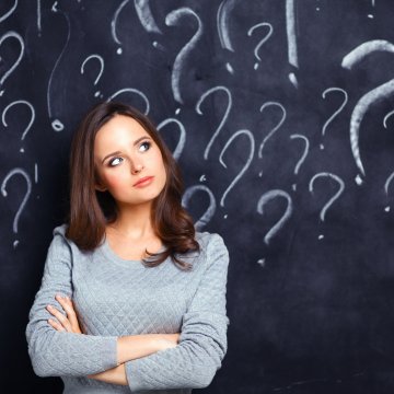 credit repair lexington law woman wondering question marks drawn on blackboard in the background